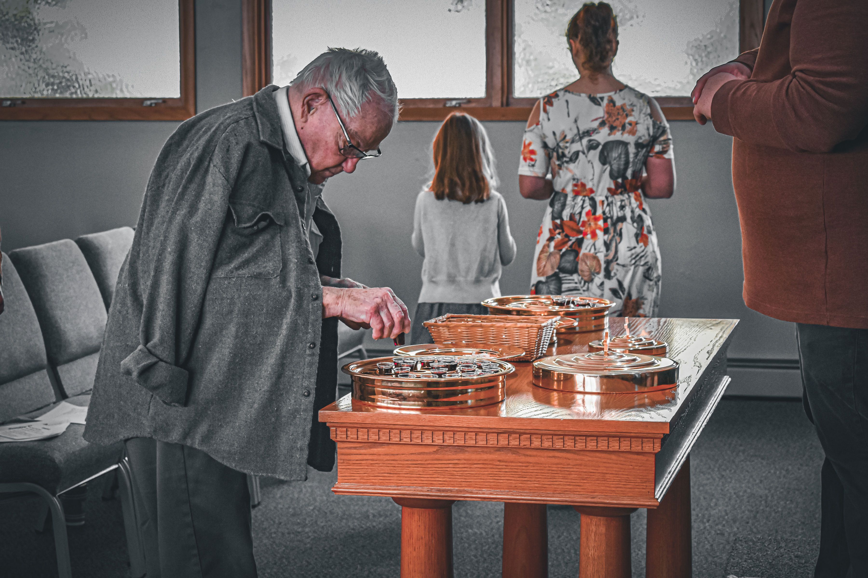 A member of Cedar Creek preparing communion